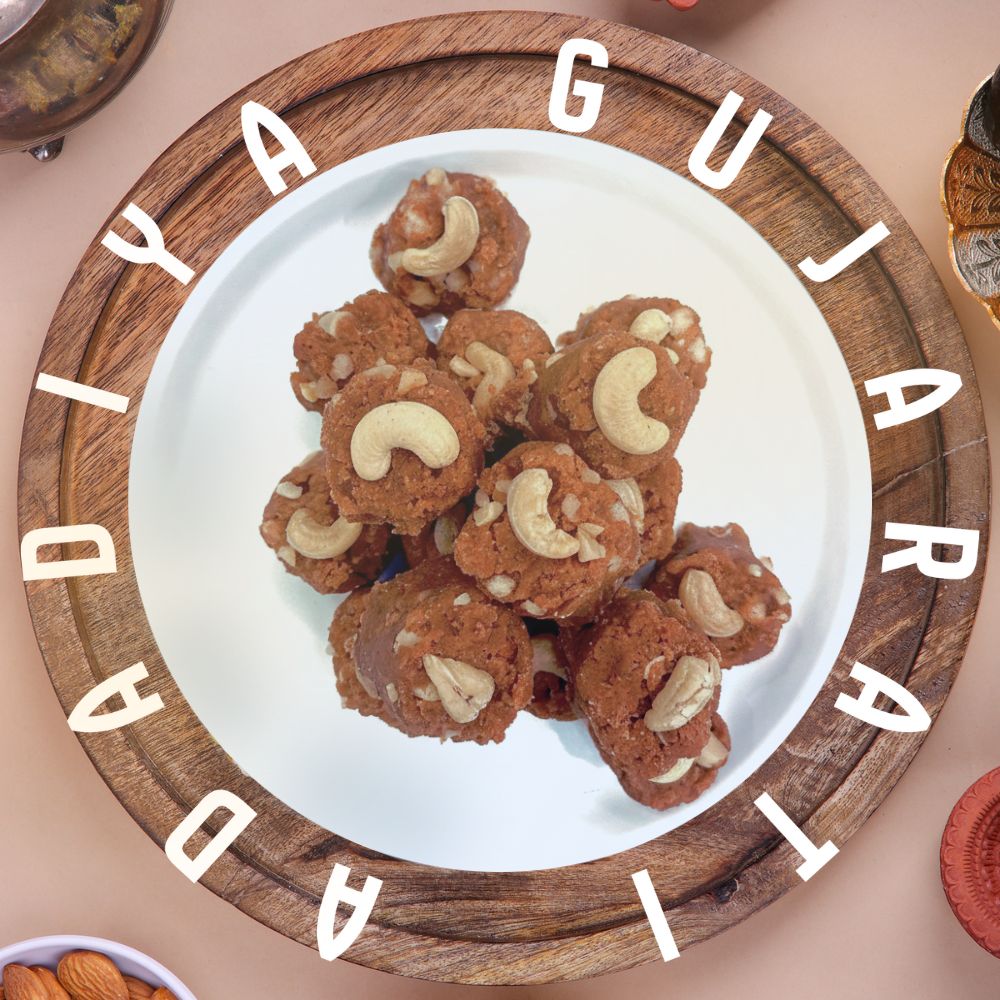 Plate of adadiya with cashews on a wooden tray with 'Adadiya Gujarati' text.