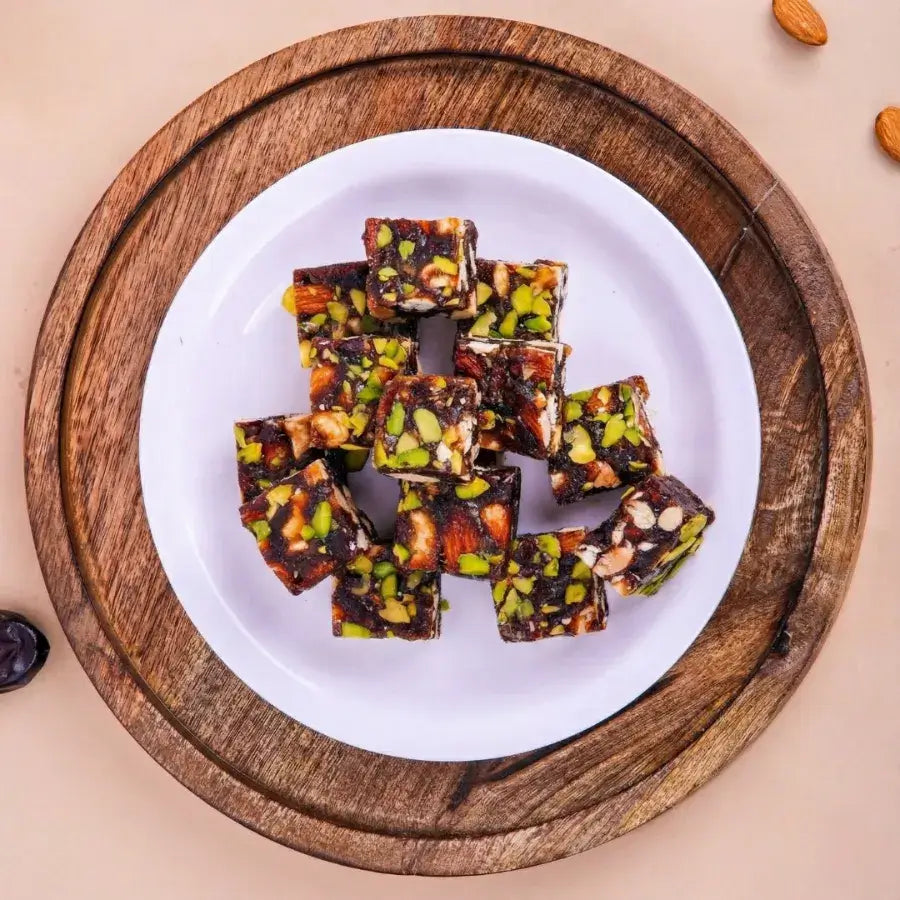 Buy Khajur Chikki online or get Khajur chikki delivery India, featuring the best Khajur dry fruit chikki online from Surat.